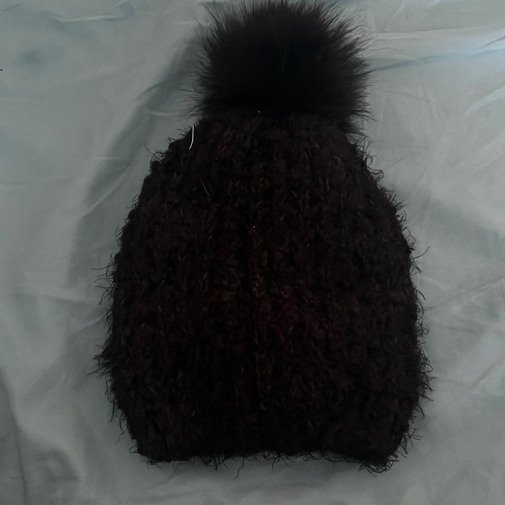 Black furry hat with pom-pom